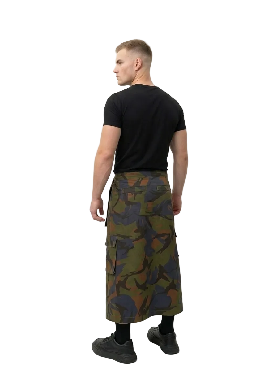 Man wearing a black t-shirt and camouflage skirt on a white background