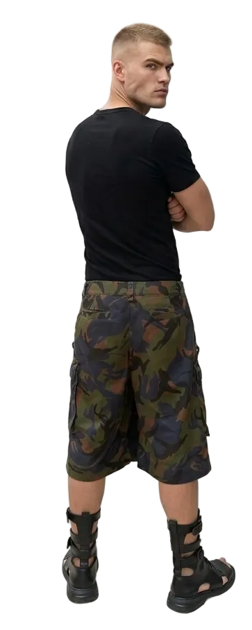 Man wearing camouflage cargo shorts and black shirt on a white background